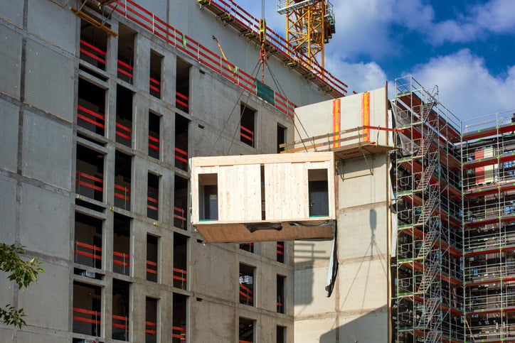 Construction site of an office building. The new structure will be built in modular timber construction - Sustainable construction practices 